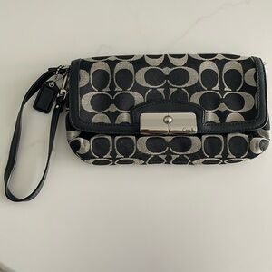 Coach “C” black wristlet bag. Magnetic clasp. Great condition.
